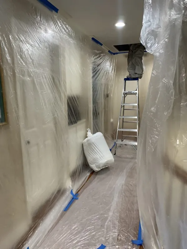 Hallway sealed off with plastic sheeting before attic insulation work